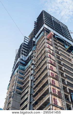 Bottom View Of An Under Construction Skyscraper In Seattle On A Clear Day, Washington, Usa.