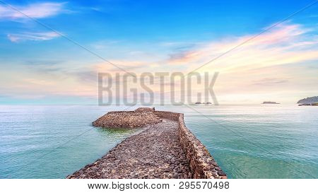 The Rock Pier With Beautiful Calmness Sunrise Seascape At Koh Chang In Thailand