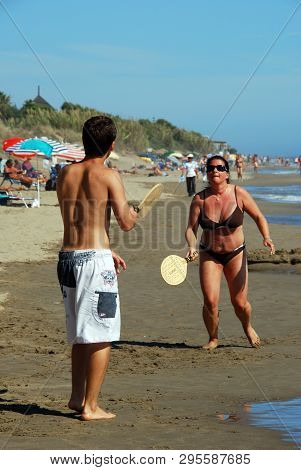 Marbella, Spain - September 12, 2008 - Couple Playing Bat And Ball On Playa De La Vibora Beach, Elvi