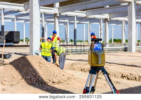 Total Center Device On Tripod With Laser For Leveling Other Devices To Level Construction Site.