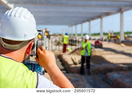 Surveyor Engineer Is Measuring Level On Construction Site. Surveyors Ensure Precise Measurements Bef