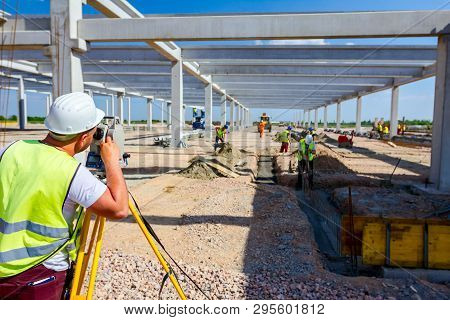 Surveyor Engineer Is Measuring Level On Construction Site. Surveyors Ensure Precise Measurements Bef
