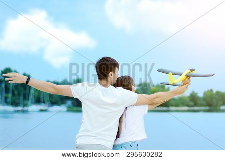 Young Smiling Woman In Light Clothes Is Holding White Racket And Ball In Her Hands. Cheerful Female 