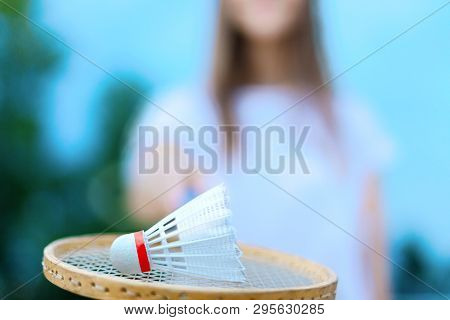 Young Smiling Woman In Light Clothes Is Holding White Racket And Ball In Her Hands. Cheerful Female 