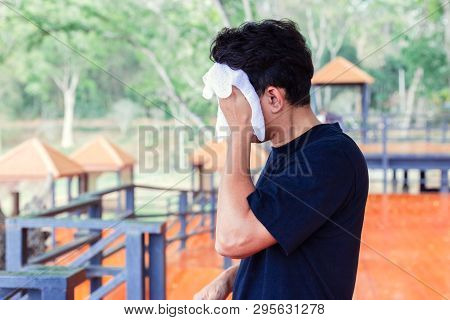 Man Wiping Off The Sweat In The Parks.