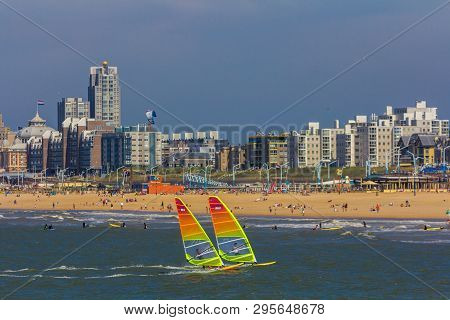Scheveningen, The Hague, The Netherlands - June 27 2018: Speeding Windsurfers Sailing Off The Beach 