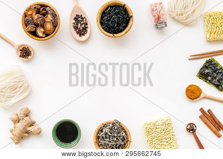 Chinese And Japanese Food Cooking With Ginger, Spices And Noodles Frame On White Background Top View