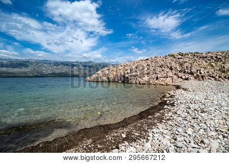 Quiet Bay With Paklenica National Park Mountains In Background. Beautiful Ocean And Dramatic Blue Sk