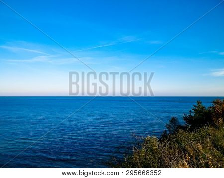 Baltic Sea From Cliff In Mechelinki, Poland. Nature And Travel Concept. Copy Space On Blue Sky.