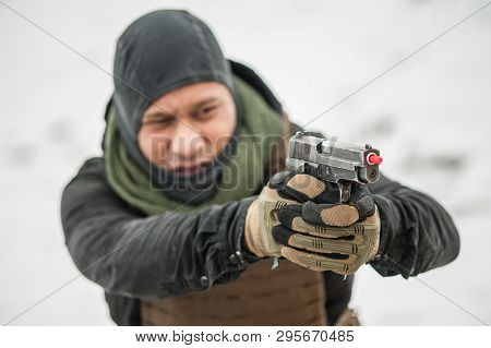 Close-up View Of Shooter Hands Holding Gun With Safety Stick