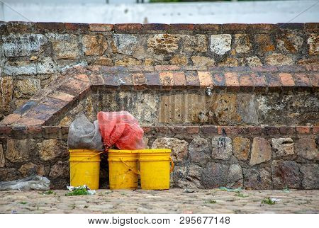 Yellow Paint Drums Waiting To Be Recollected At A Street In The Colonial Town Of Villa De Leyva, In 