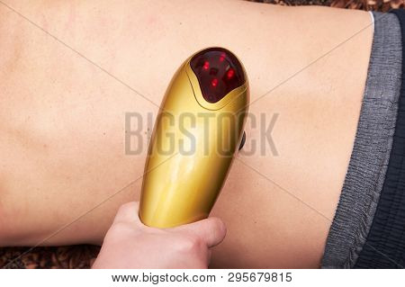 Male Patient Receive Electrostatic Therapy Procedure On His Back. Electrostimulation Massage Close-u