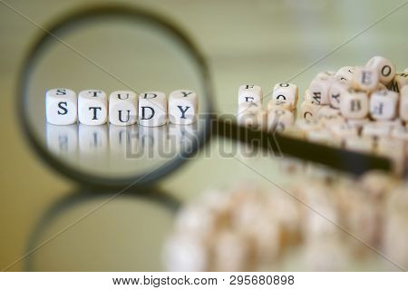 Learn The Alphabet. Inscription Study, Lined With Cubes Through A Magnifying Glass. Golden Backgroun