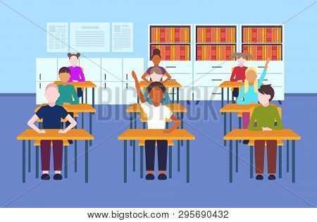 Mix Race Pupils Sitting Desks Raising Hands During Lesson Education Concept Modern Elementary School
