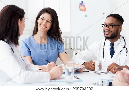 Cardiology Conference. Diverse Doctors Having Discussion At Meeting In Clinic