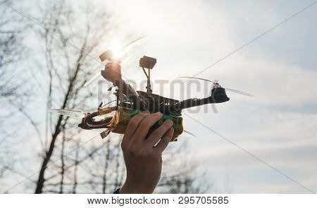 Pilot Racing Drone Holds In His Hand Fpv Copter Before Launching It. A Small High-speed Aircraft Wit