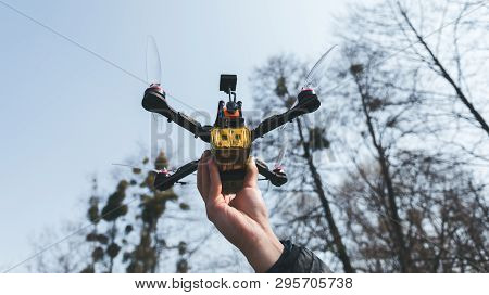 Pilot Racing Drone Holds In His Hand Fpv Copter Before Launching It. A Small High-speed Aircraft Wit