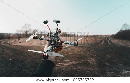 Pilot Racing Drone Holds In His Hand Fpv Copter Before Launching It. A Small High-speed Aircraft Wit