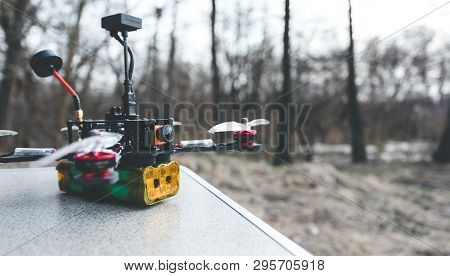 Fpv Drone Lies On The Table. The Pilot Sets Up His Racing Drone Before The Flight.