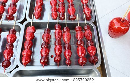 Caramelized Red Apple And Strawberries  For Sale At Kiosk On The Street During The Carnival Festival