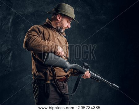 Opening Of The Spring Hunting Season. A Man Cleans Rifle Barrel, Maintenance Before Hunting.