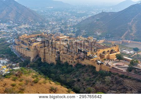 View Of Amber Fort And Palace In Maotha Lake From Mountain. Jaipur. Rajasthan. India