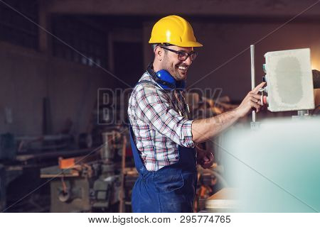 Carpenter Doing His Job In Carpentry Workshop