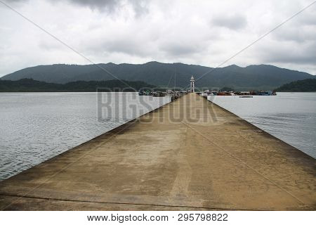 Cement Jetty Bridge Stretches To The Sea. Used For The Docking Of Ships, After Finding Out The Fish.