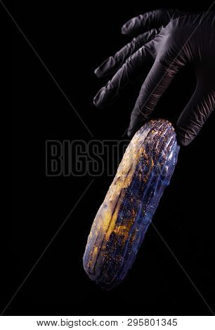 Beautiful Bright Eclair With Blets On A Dark Background.