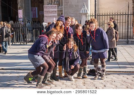 Paris, France - November 4, 2012: Beautiful Young Tourists In Paris, Making Funny Picture Near Notre