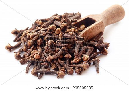 Organic Cloves In A Scoop Over White Abckground