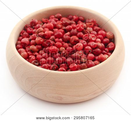 Pink Peppercorn In A Wooden Bowl Over Whtie Background