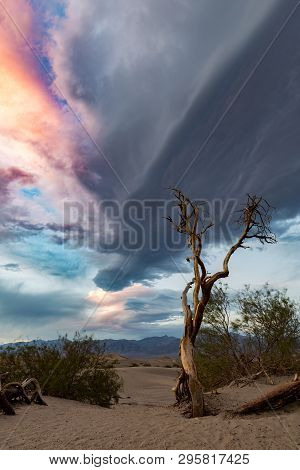 The Sun Sets And Creates Beautiful Colors On Giant Clouds Over The Desert Of Death Valley National P