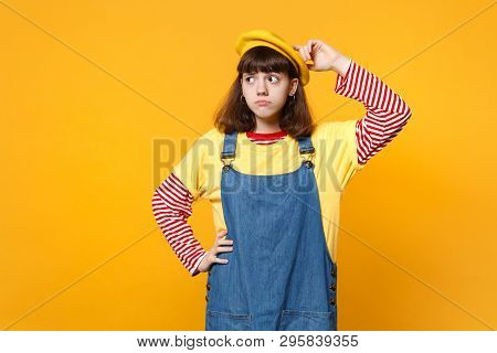 Portrait Of Preoccupied Girl Teenager In French Beret, Denim Sundress Putting Hand On Head, Looking 