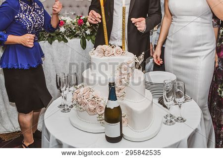 Mother In Low Dancing With Bride And Groom On Wedding Party In Restaurant. Wedding Table Setting Wit