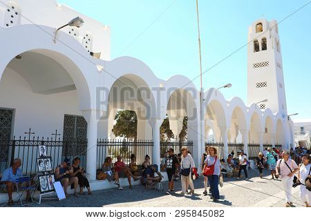 Santorini, Greece - July 19, 2018: Tourists Walking In Santorini Near Orthodox Church, Oia Village, 