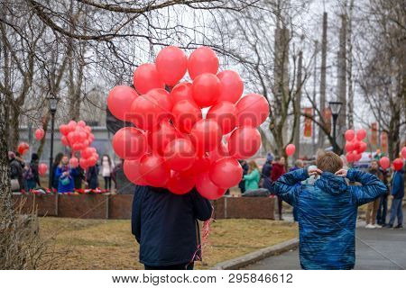 Hooded Yellow Figure With Red Balloon In Dark Creepy Corridor