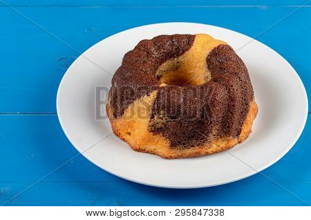 Kuglof On The White Plate And Blue Background