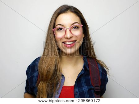Portrait Of Beautiful Smiling Student Girl. Young Nerd Student With Glasses On White Background.