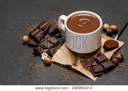 Cup Of Hot Chocolate And Pieces Of Chocolat On Dark Concrete Background