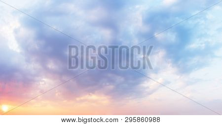 Fantastic Sunset Sky In Pastel Colors In Shades From Purple To Orange. Clouds Background. Fluffy Sof