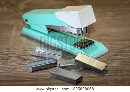 An Old Green Tacker With Spare Cramps