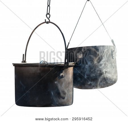 Two Sooty Old Cauldrons In Fume Isolated On White Background