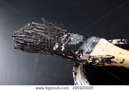 Old Paint Brush And Metal Can With Paint. Accessories For Painting Oil Paint Dirty With Black Paint.