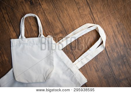 White Tote Canvas Fabric Eco Bag Cloth Shopping Sack On Wooden Background / Zero Waste Use Less Plas