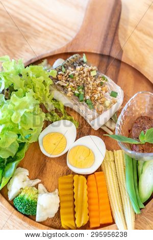 grilled sea bass with Galangal Nam phrik organic chili paste with variety organic vegetable and egg.  Thai traditional healthy food cuisine.