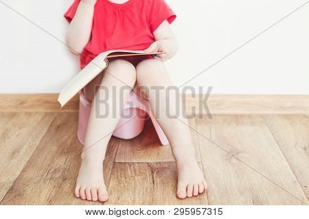 Funny Child Girl Sitting On Chamberpot, Childrens Legs Hanging Down From A Pot
