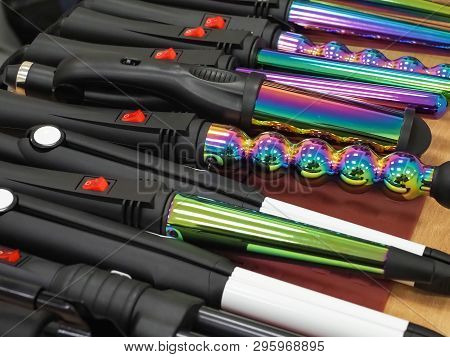 Various Hair Stylers Are Laid Out On The Table
