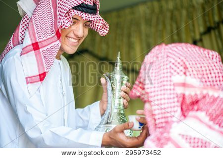 Arbic boy pouring coffee