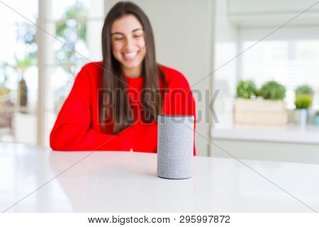 Young woman using home intelligent device, interactive voice assistant system